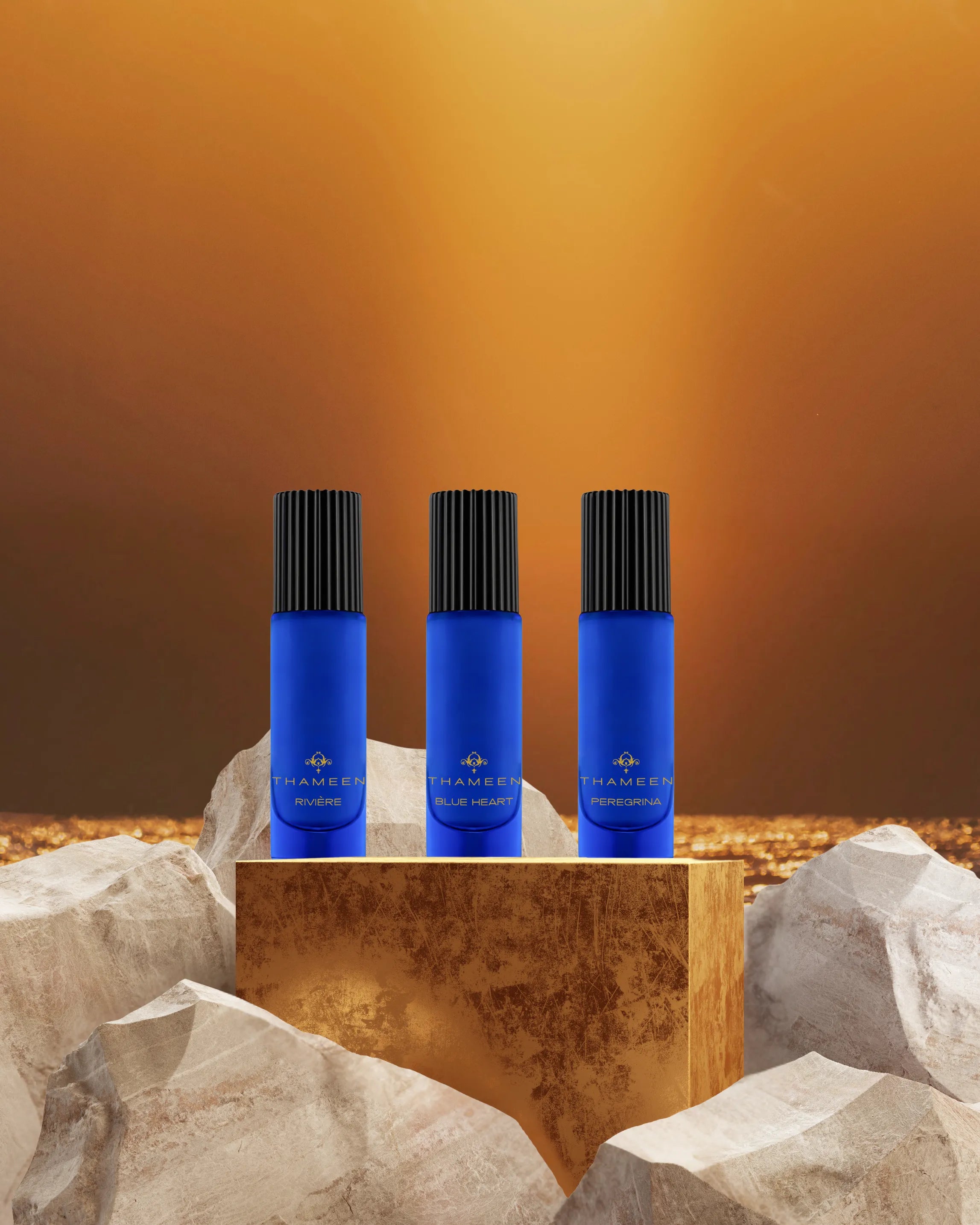 Three 10ml bottles of Thameen fragrances on a gold block with an atmospheric background